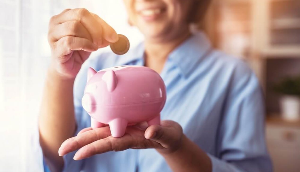 Asain Elder putting coin money to piggy bank saving, family, sa Asain Elder putting coin money to piggy bank saving, family, savings, age and people concept - smiling senior couple with money and piggy bank at home.