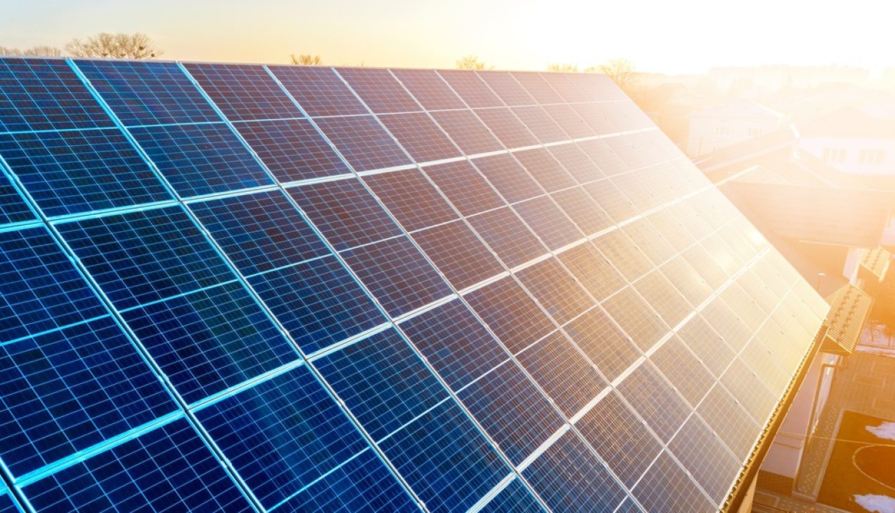 Close-up surface of lit by sun blue shiny solar photo voltaic pa Close-up surface of lit by sun blue shiny solar photo voltaic panels. System producing renewable clean energy. Renewable ecological green energy production concept.