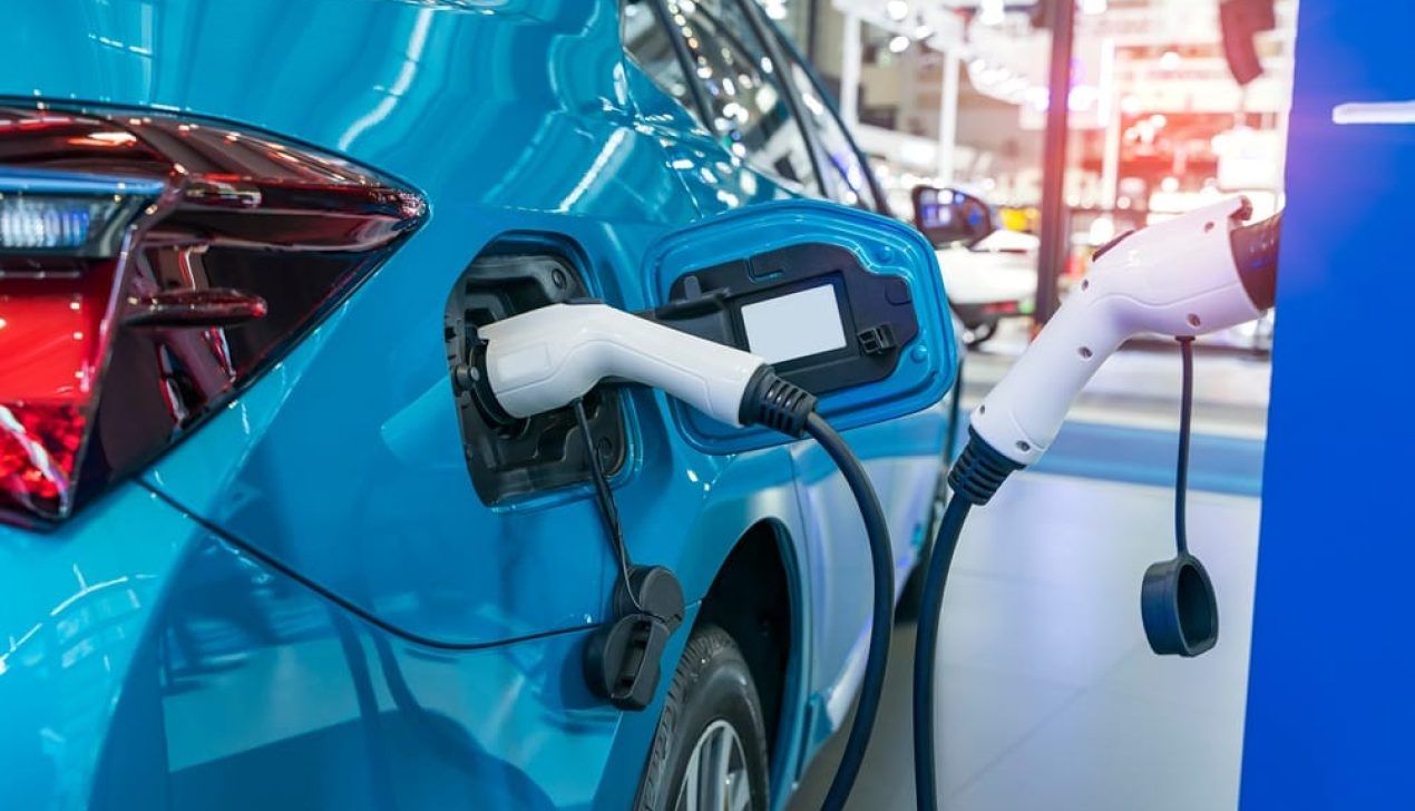 Electric car charging on parking lot with electric car charging Electric car charging on parking lot with electric car charging station.