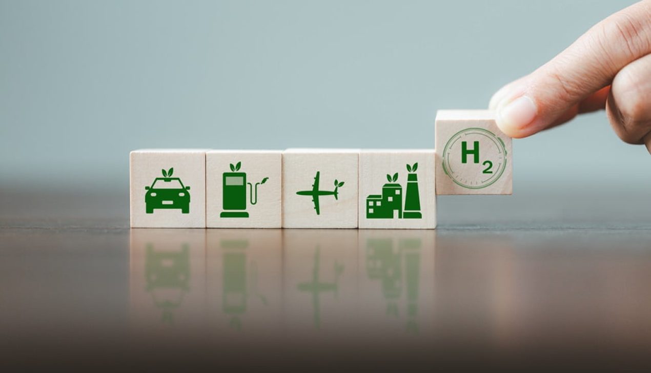 Free Carbon, alternative energy and global climate change concepts. Hand flipping wooden cube blocks with CO2 Carbon dioxide, change to H2 Hydrogen text on table background. Sustainable car energy. Free Carbon, alternative energy and global climate change concepts. Hand flipping wooden cube blocks with CO2 Carbon dioxide, change to H2 Hydrogen text on table background. Sustainable car energy.